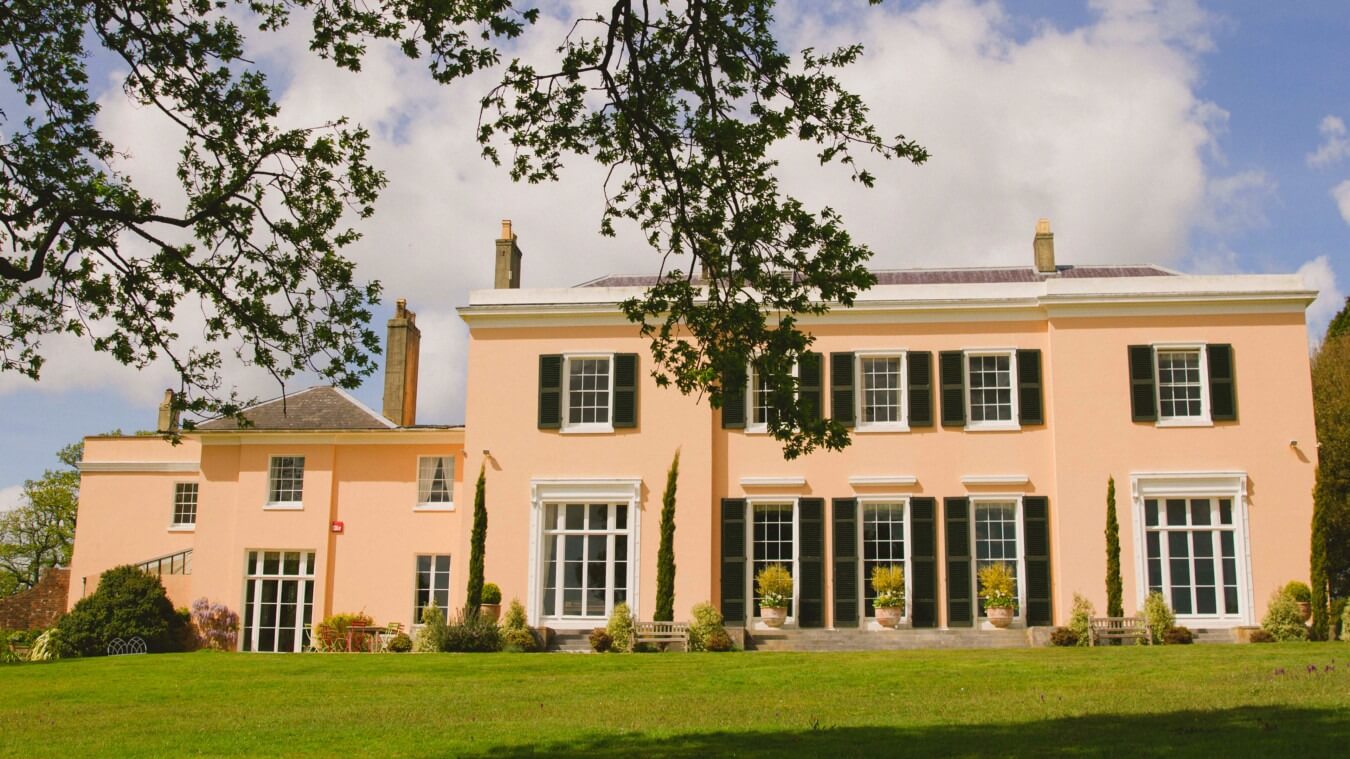 Bignor Park wedding venue Georgian house West Sussex with elegant symmetry, black shutters and expansive South lawn for outdoor celebrations