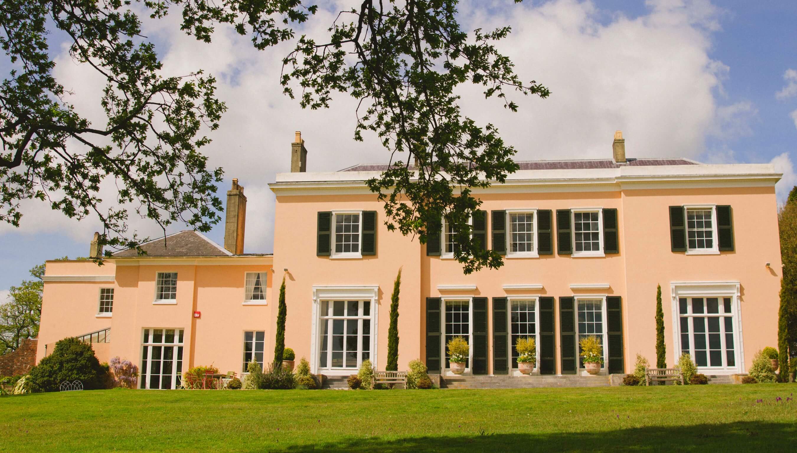 Bignor Park wedding venue Georgian house West Sussex with elegant symmetry, black shutters and expansive South lawn for outdoor celebrations