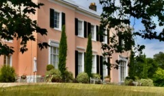 Bignor Park Georgian house exterior West Sussex with pastel façade, shuttered windows and landscaped gardens wedding venue setting