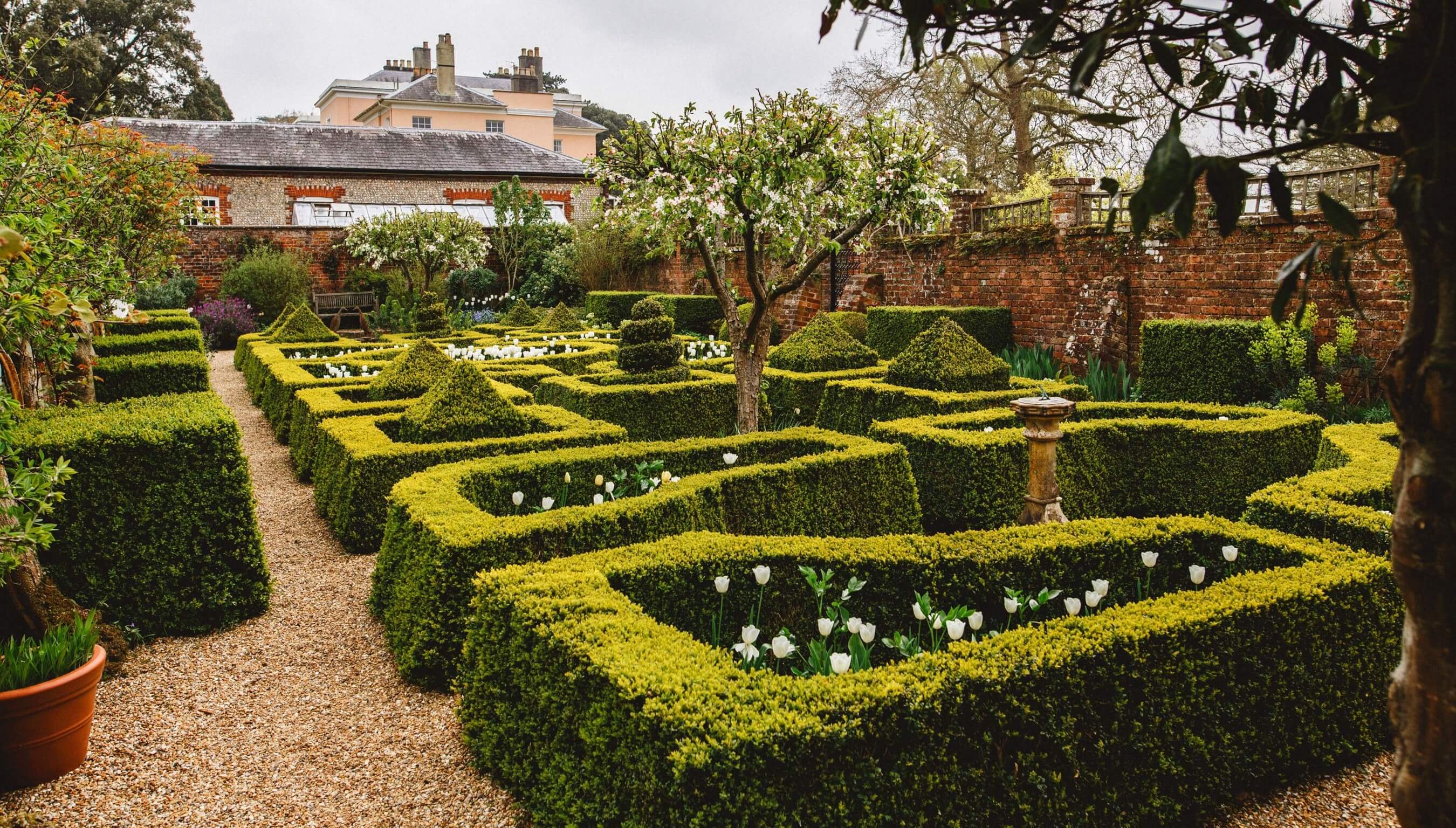 Formal gardens at Bignor Park in West Sussex with manicured hedges and historic house setting