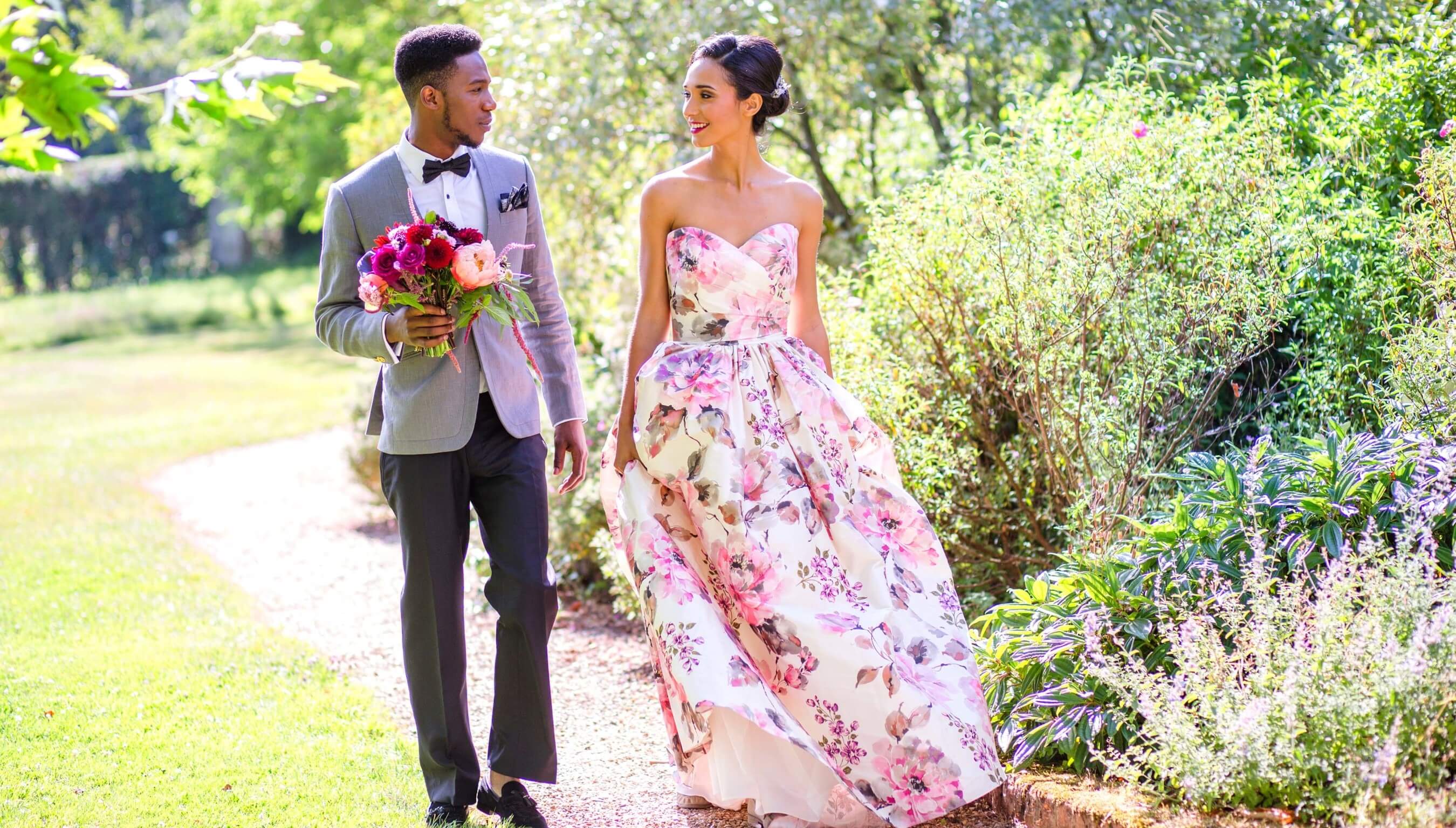 Couple walking through gardens at Bignor Park in West Sussex, stylish outdoor wedding venue