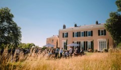 Wedding drinks reception at Bignor Park in West Sussex with guests on the South lawn outside the country house