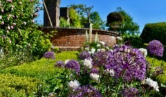 Formal gardens at Bignor Park West Sussex with colourful summer flowers and brick terraces, perfect wedding venue backdrop