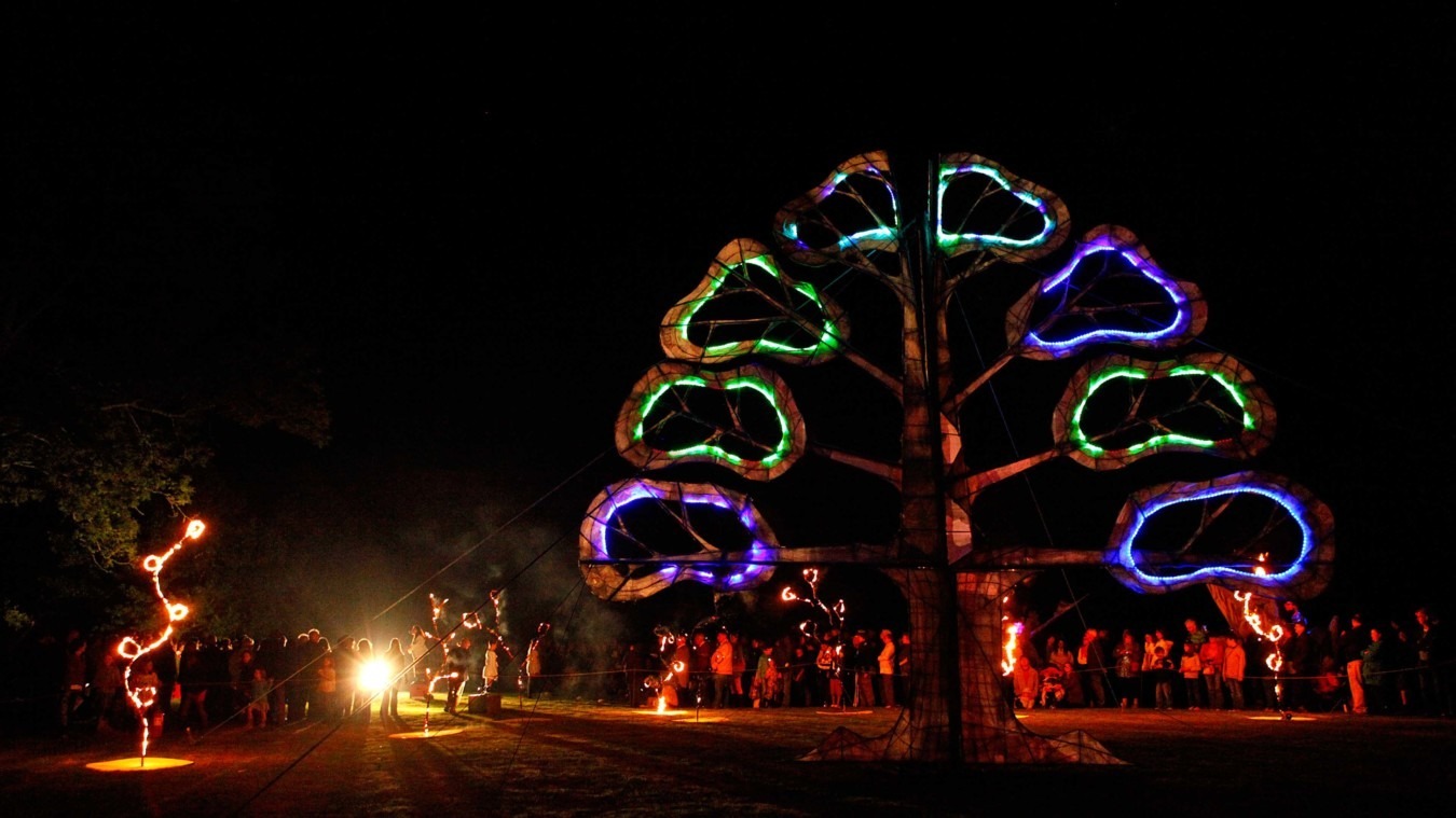 A large illuminated tree sculpture on the Croquet lawn at Bignor Park in West Sussex