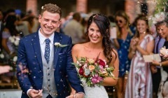 New married couple leaving the Greek Loggia being showered in confetti at wedding venue Bignor Park in West Sussex