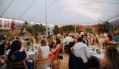 Wedding guest at an outdoor wedding breakfast in the Stables Quadrangle at Bignor Park in West Sussex