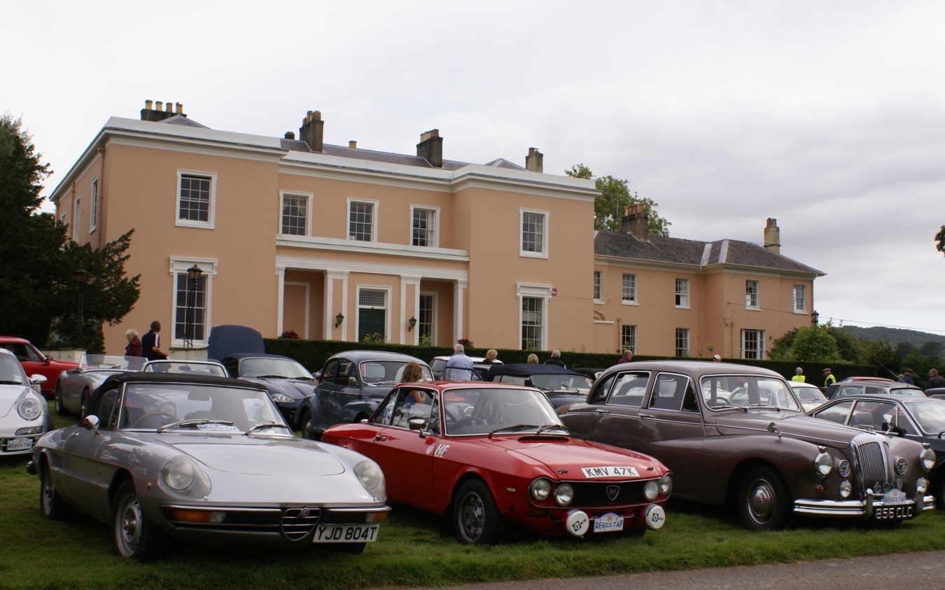 Vintage car show in front of main estate house at an event held at Bignor Park in West Sussex